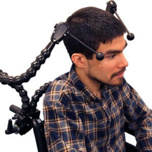 A man sitting in a wheelchair with an adjustable flex dual ultimate switch.