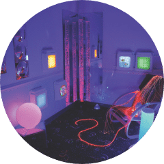 Dimly lit play room with light up toys.