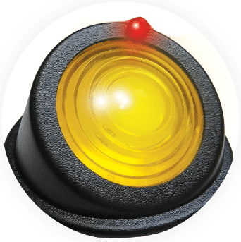 A yellow button with a black base and a red light.